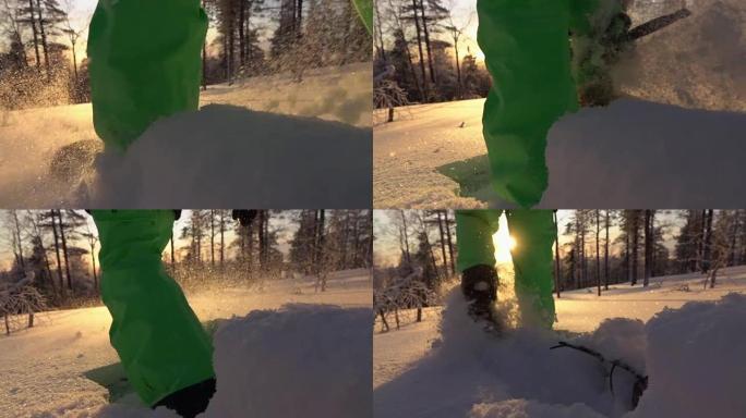 在华丽的冬季日出时，慢动作特写雪鞋在新鲜的粉末雪上行走