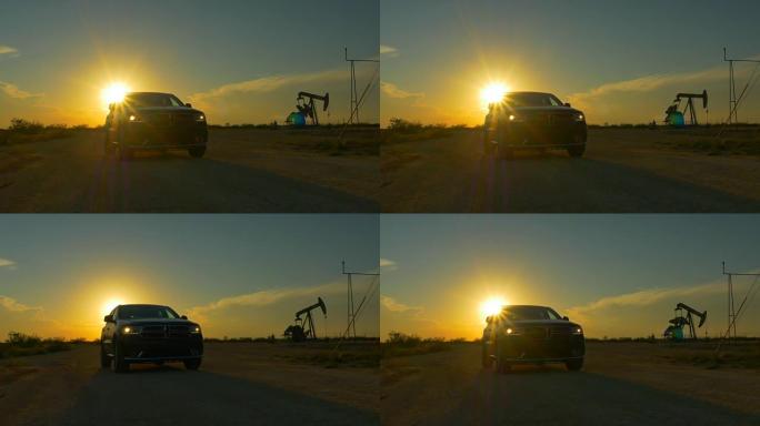 金色日落时的SUV汽车和工作油泵千斤顶