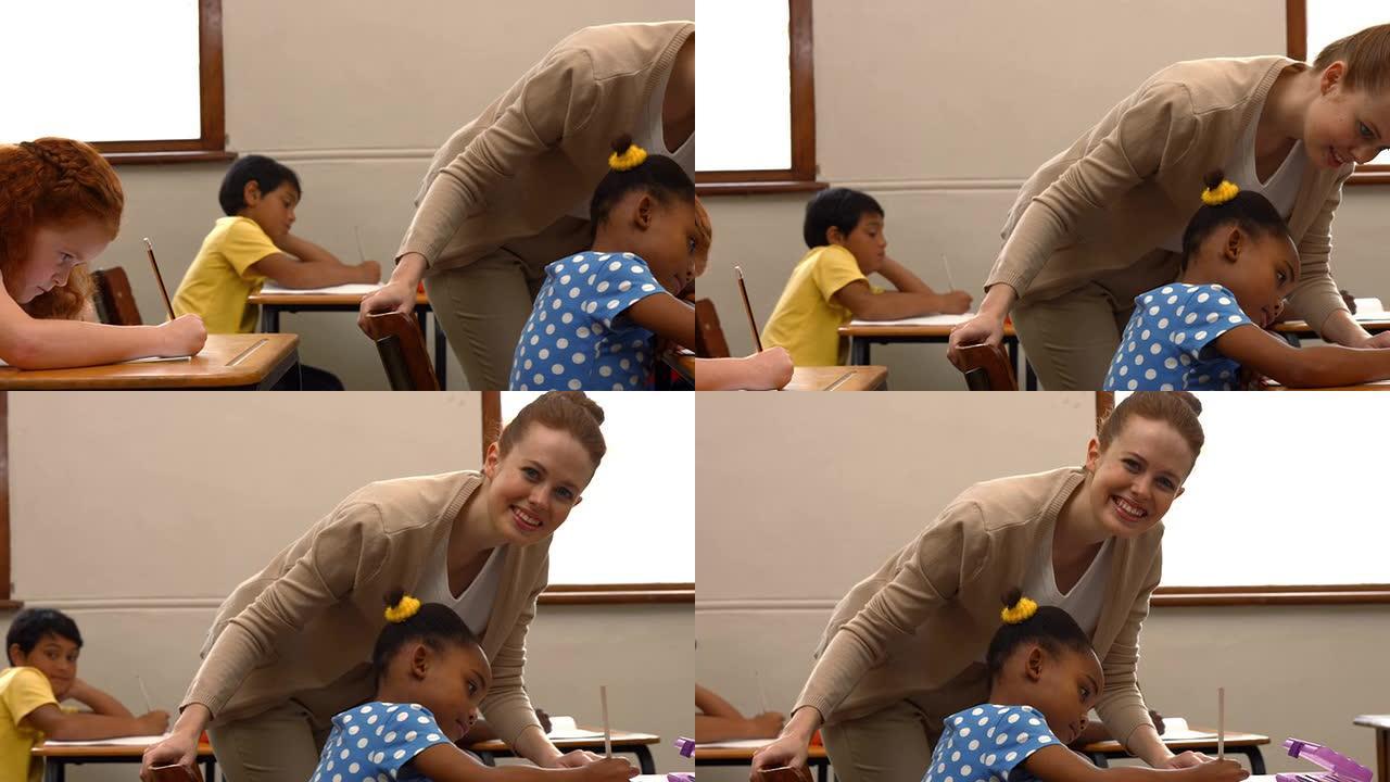 老师在课堂上帮助一个小女孩
