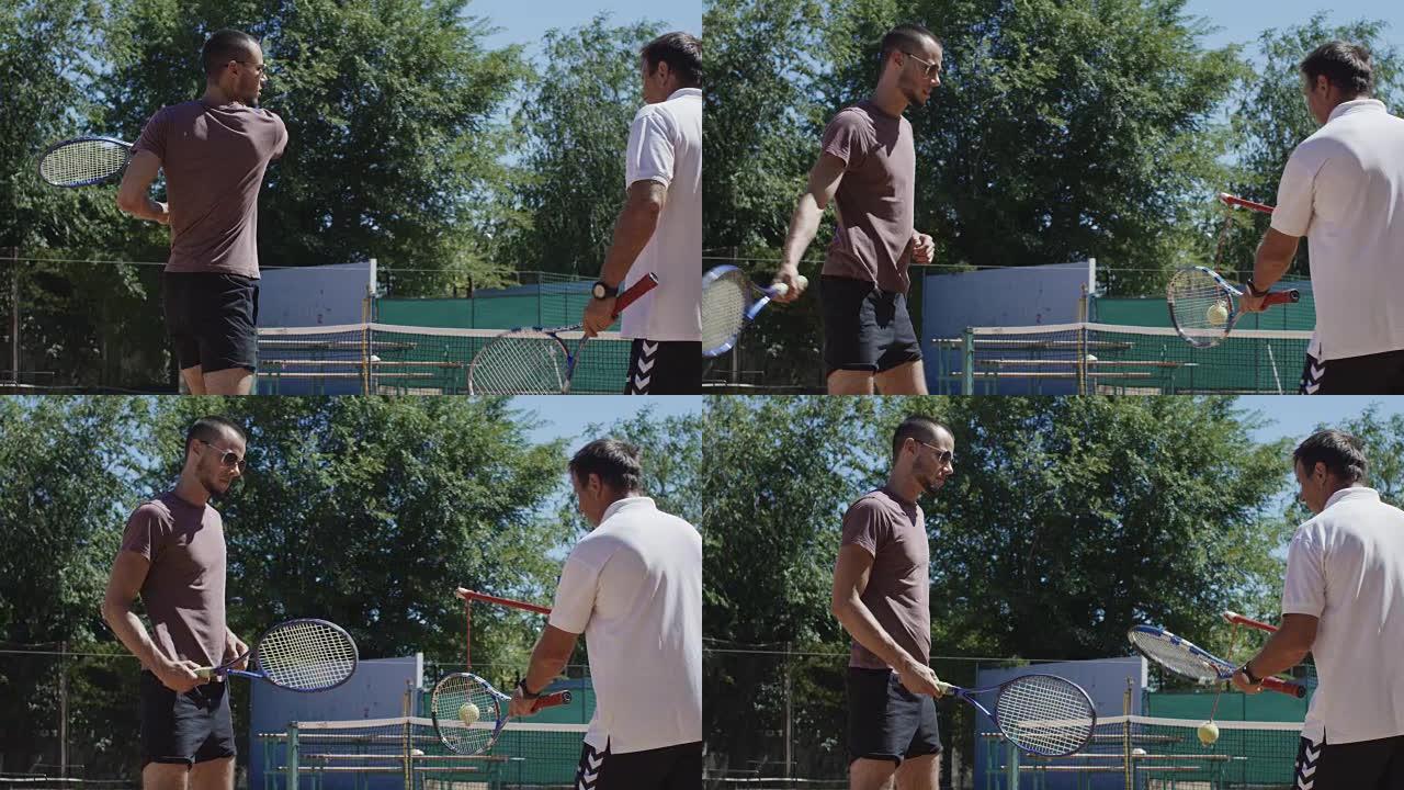 与男子一起在球场上工作的网球教练