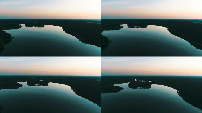 日落时湖泊和草地的鸟瞰图