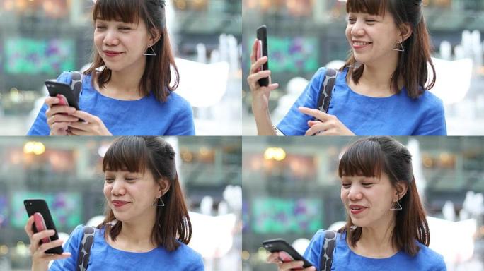 微笑的女人使用智能手机