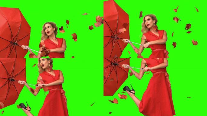 漂亮的女人在绿色屏幕上撑着一把破雨伞