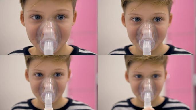 男孩通过吸入器呼吸。他脸上的面具，特写。