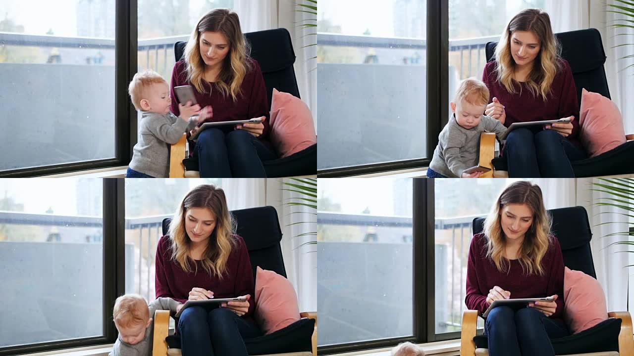 母亲在照顾婴儿4k时使用数字平板电脑
