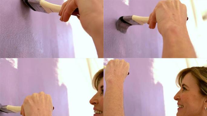 女人用刷子重新装饰墙壁