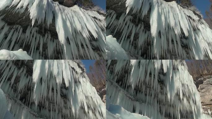 特写: 冬天，数百个闪闪发光的冰柱悬挂在山崖上