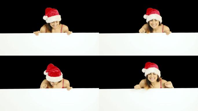 穿着圣诞老人帽子的美女黑发女人展示白色海报