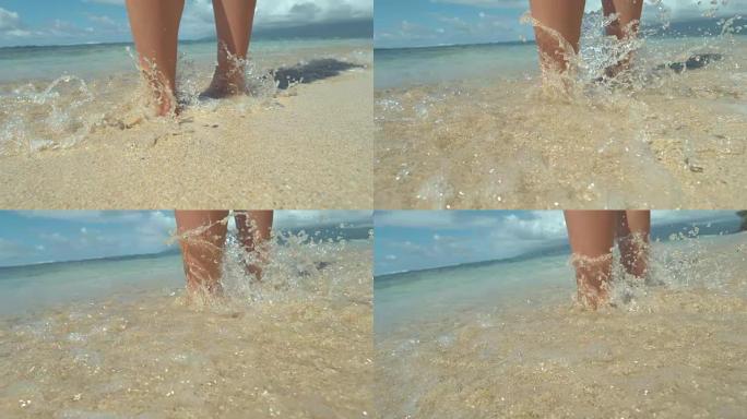 特写: 无法辨认的年轻女子站在沙滩上，女人弄湿了脚