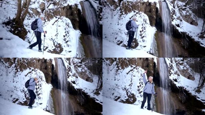 Beautiful female hiker walking near the waterfall