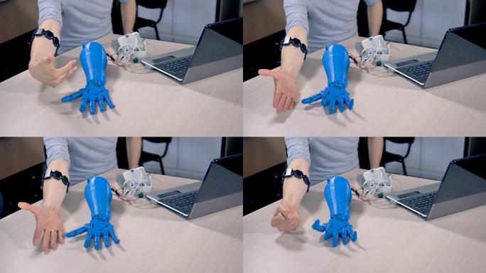 工程师通过不同的动作来引导机器人的手。