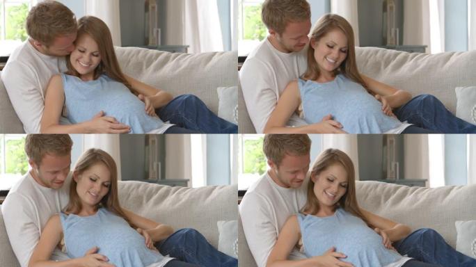 与R3D拍摄的孕妇在沙发上放松的夫妇