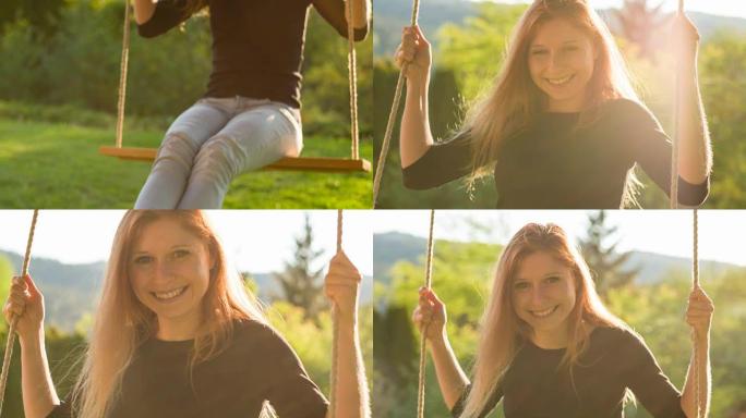 快乐的年轻女子坐在公园树下的绳索秋千上，被阳光照亮，微笑着对着镜头