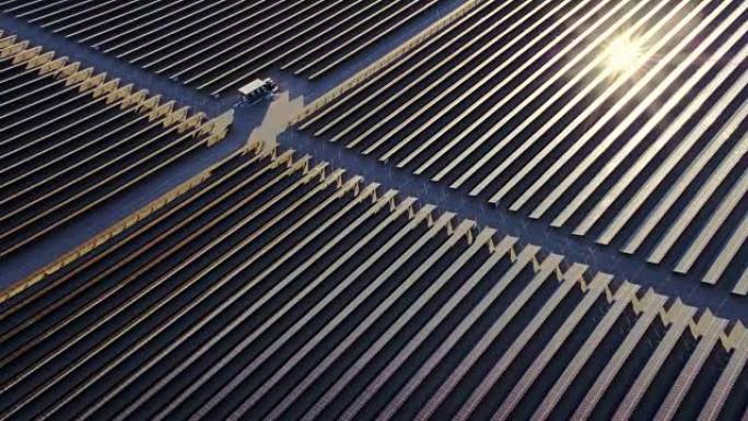 鸟瞰图飞越沙漠中的大型太阳能农场，创造清洁的可再生能源