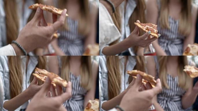 手握披萨和可乐的特写镜头