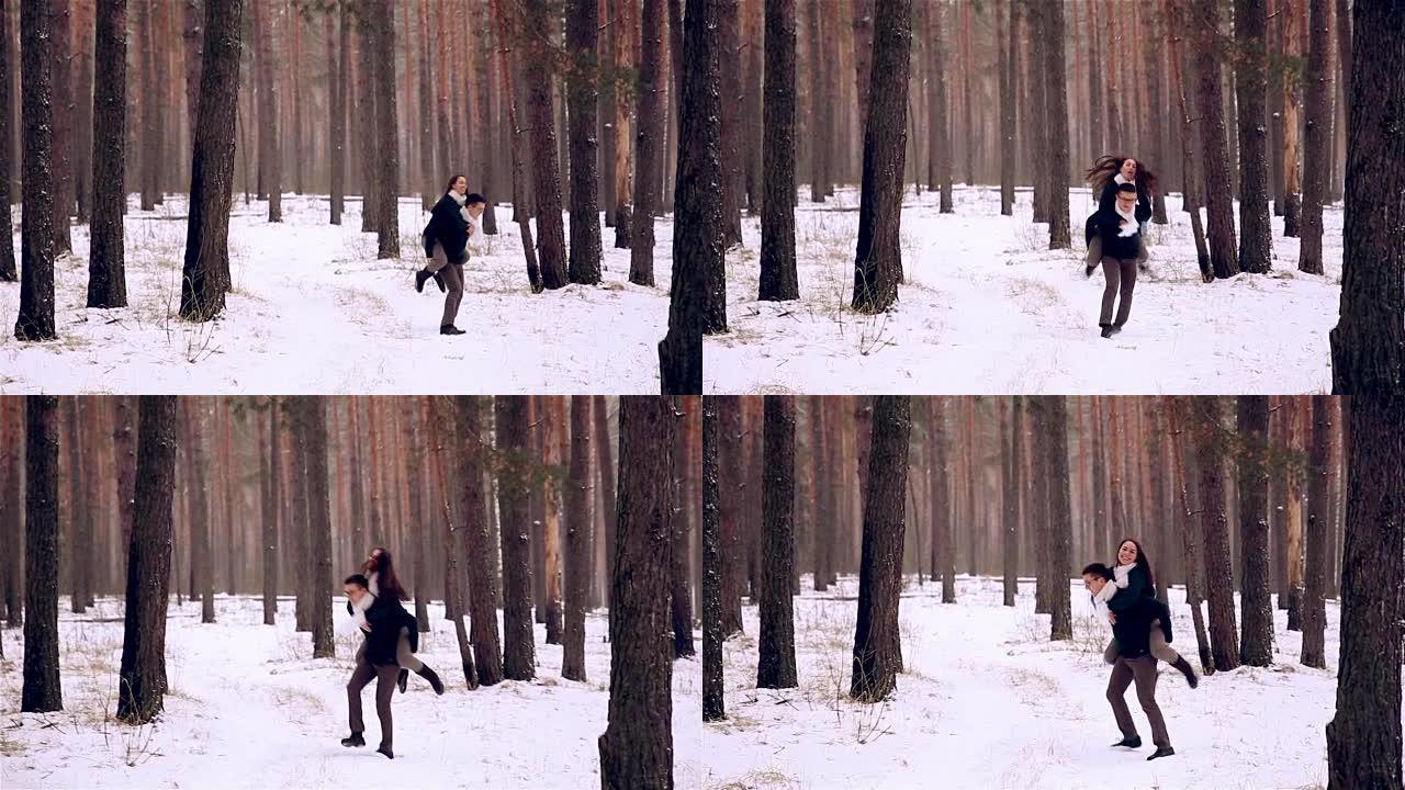 快乐的年轻夫妇在冬季森林里玩得开心
