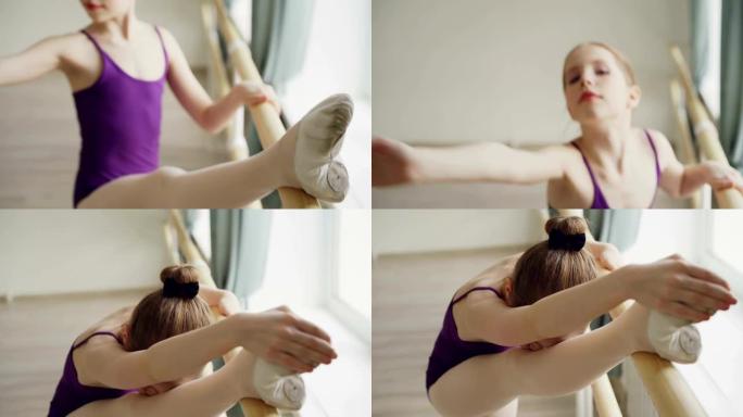 在单独的课堂上，开始芭蕾舞演员在芭蕾舞酒吧练习伸展腿的动作的近距离拍摄。灵活优雅的女孩穿着足尖鞋和紧