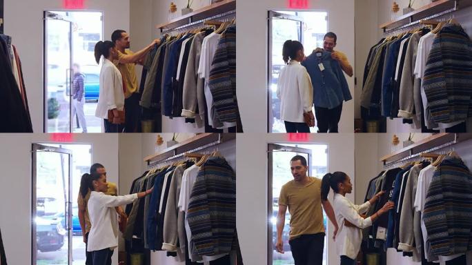 西班牙裔年轻夫妇在服装店看衣服
