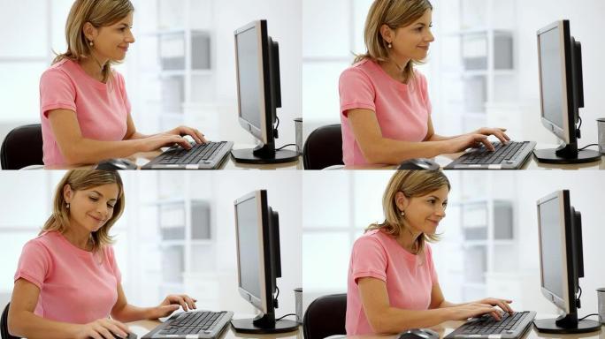 在办公室里用电脑工作的年轻女人。