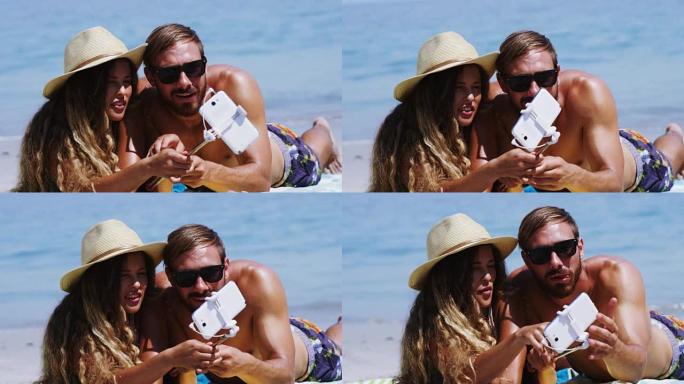 情侣在海滩用手机自拍