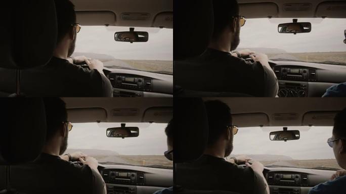 车内视图。两个人开车穿过空旷的道路。戴墨镜的朋友一起旅行