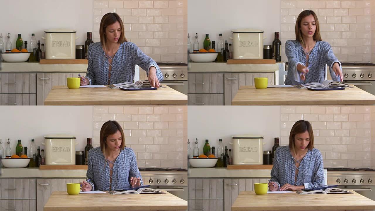 女人在厨房的桌子上研究并做笔记，锁定，在R3D上拍摄
