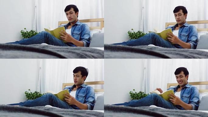 一个男人躺在床上在卧室里看书