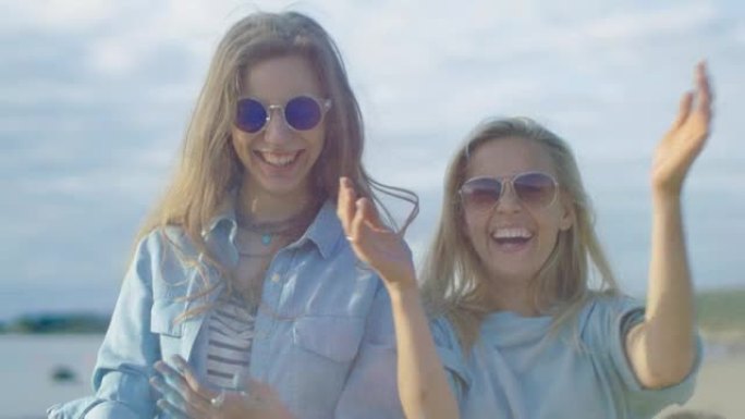 两个美丽的快乐女孩笑着庆祝胡里节在空中扔五颜六色的粉末。他们有自己的生活。