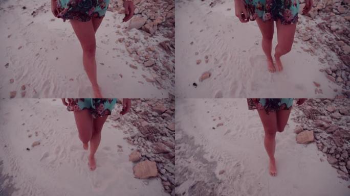 波西米亚风女孩的腿在沙滩上行走