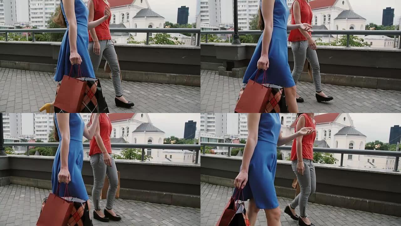 两个漂亮的年轻女性朋友带着购物袋散步，聊天玩得开心，侧视，慢镜头