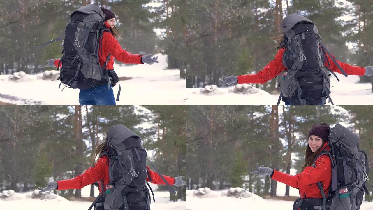 女孩在大雪下转身。旅行者，冬日森林中的徒步旅行者正面肖像。徒步旅行，爱情，纯洁，自由的概念。