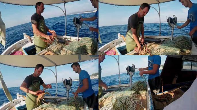 渔民从渔船上的网中取出龙虾