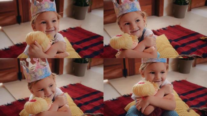 带公主皇冠帽子的可爱小女孩玩洋娃娃