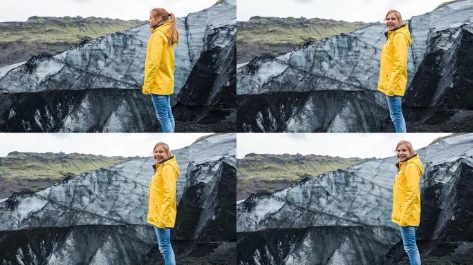欣赏被火山灰覆盖的冰岛冰川的女性游客