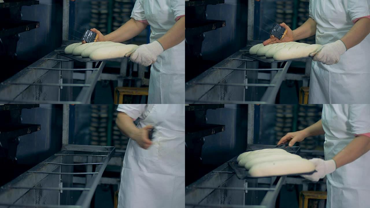 一名工人准备面包用于银行业务并进行表面切割。