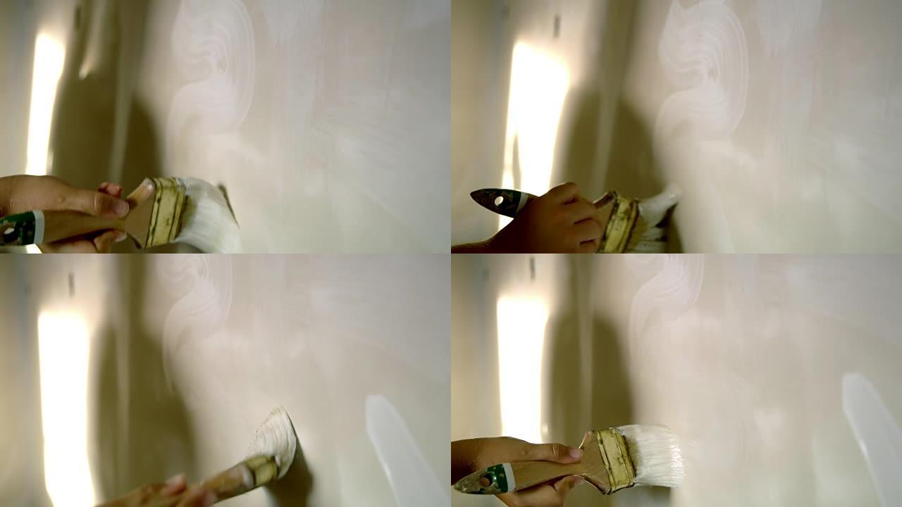 女人画白色油漆在墙上漩涡，慢动作