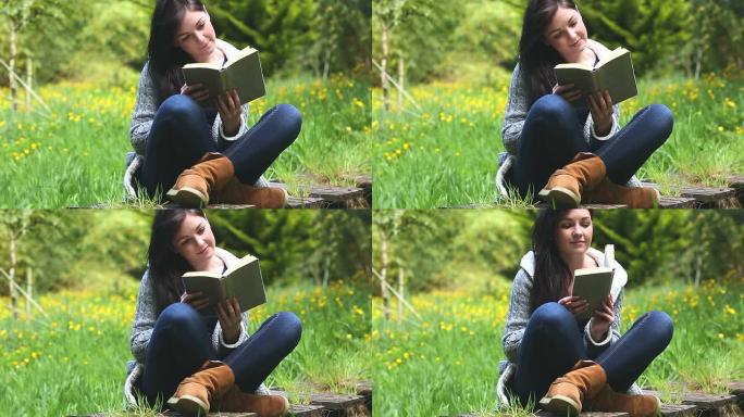 女人坐在草地上看书