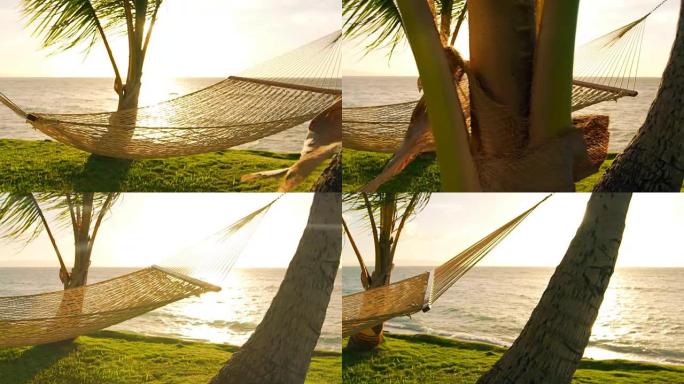 日落时的吊床和棕榈树慢动作。豪华度假放松生活方式。吊床在两棵棕榈树之间随风摆动。后院海滨房地产。毛伊