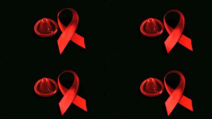 艾滋病红丝带符号掉落在避孕套旁边