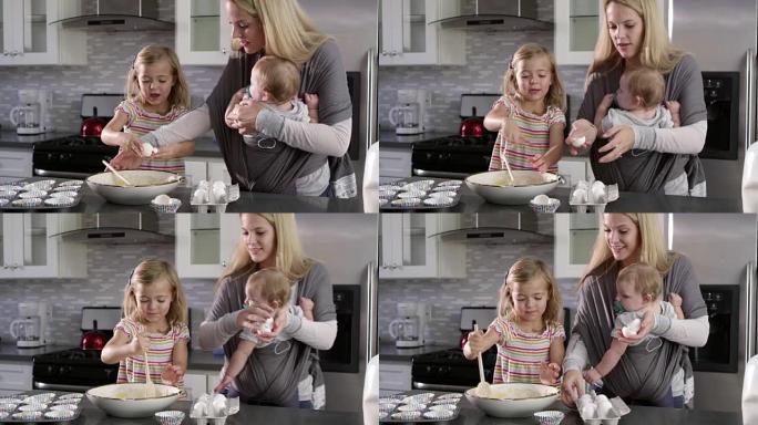年轻女孩在厨房准备蛋糕混合，妈妈展示婴儿，在R3D上拍摄