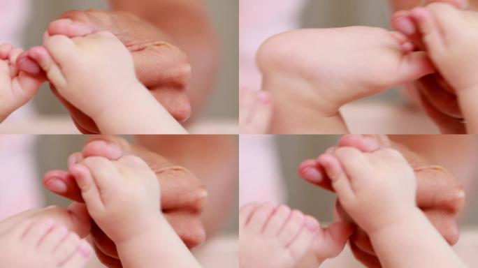 皱巴巴的手握着婴儿的手