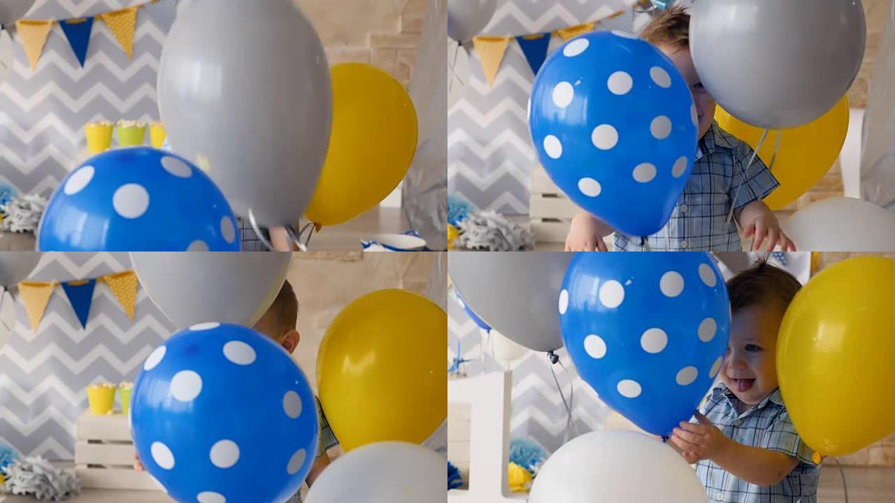 快乐的孩子正在玩生日礼物的蓝色和灰色气球。