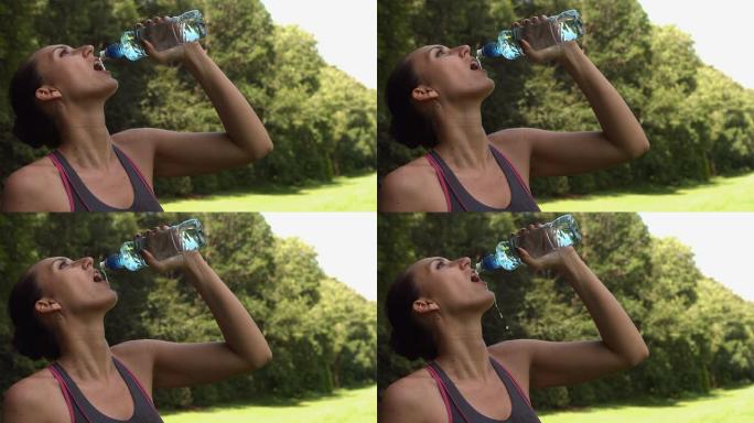 运动黑发从水瓶中饮用