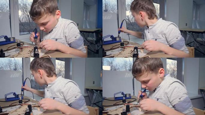一个小孩正在焊接他的现代飞行小工具