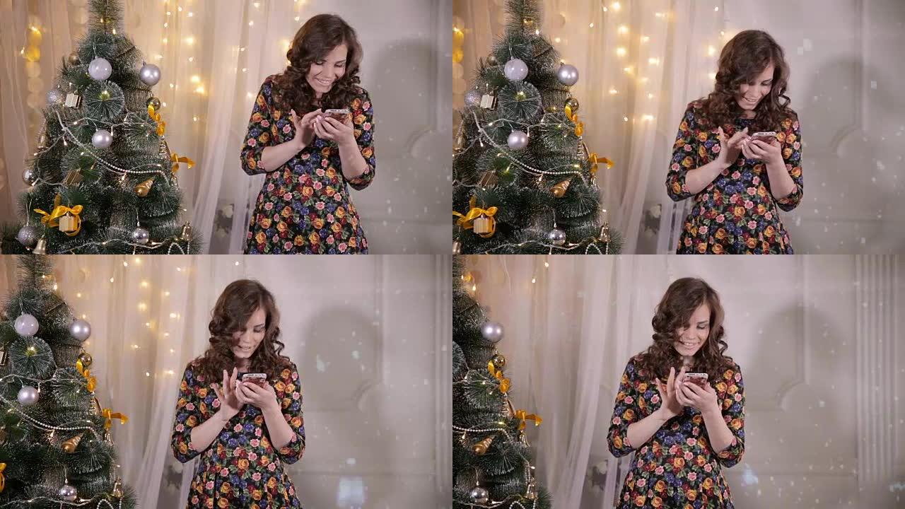 新年庆祝活动期间，迷人的女孩在圣诞树附近发送和接收短信