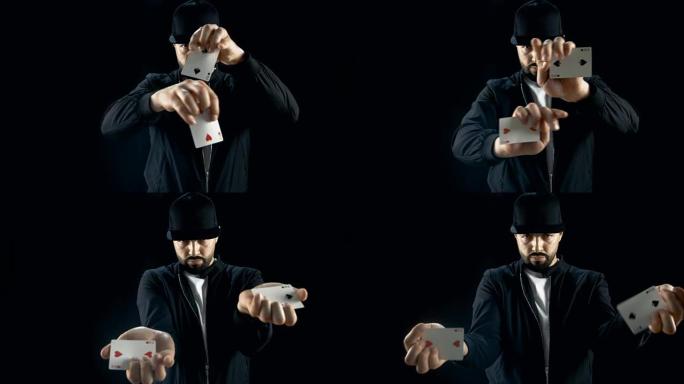 戴着帽子的专业街头魔术师表演令人印象深刻的手牌技巧。背景是黑色的。