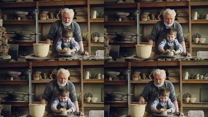 集中的孩子在他经验丰富的祖父的指导下，用陶工轮上的粘土形成锅。背景是陶瓷罐，花瓶和人物。