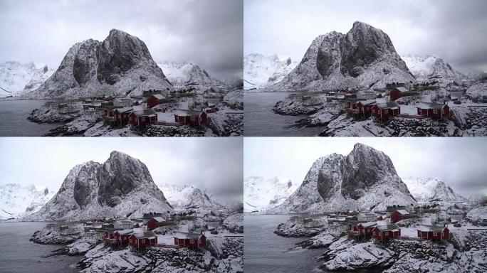 挪威罗弗滕群岛汉诺伊村多云的雪山俯视景观的4k镜头。从顶部向下移动