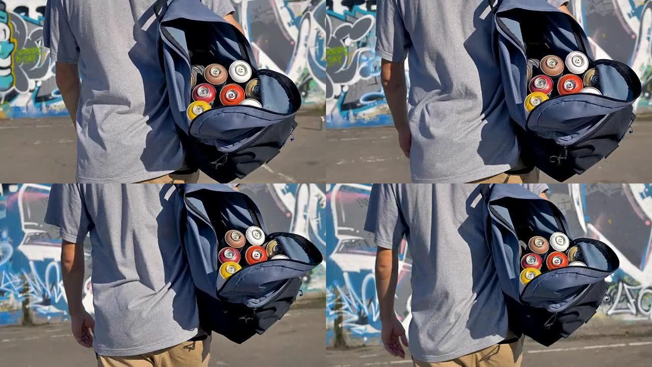 涂鸦艺术家肩上装满油漆罐的开放式背包。
