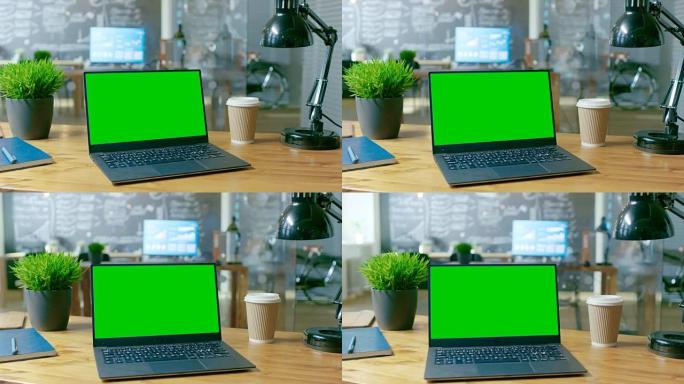 带有模拟绿屏监视器的个人计算机放在办公桌上。在白天的背景时尚创意办公室。
